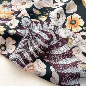 Detailed macro view of vintage floral poppy pattern and zebra stripes on silk scarf