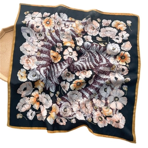 Floral silk square scarf with zebra print and yellow border on a dark background