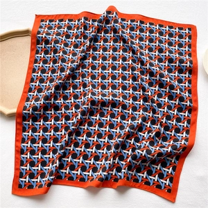 Geometric pattern square silk scarf with orange borders and satin finish texture