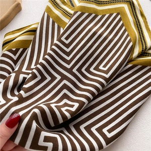 Macro detail of geometric patterned silk scarf with premium smooth texture and fine print