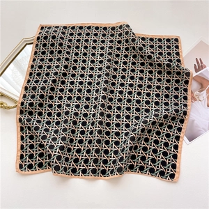 Detailed view of geometric knit pattern scarf with beige border and chic background