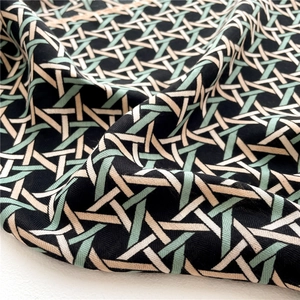 Detailed view of geometric weave pattern on a soft velvet-like square scarf