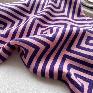 Detailed view of pink and purple geometric maze pattern scarf with silky texture