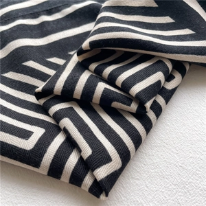 Close-up of geometric striped scarf showing premium herringbone weave and soft fabric texture