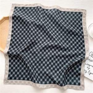 Detail of square silk scarf with geometric pattern and high-quality stitched edges
