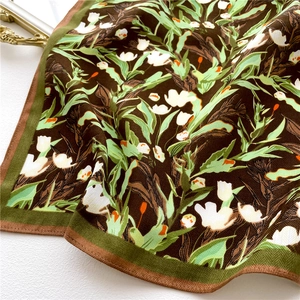 Macro detail of tulip floral print silk scarf with fine herringbone weaving texture