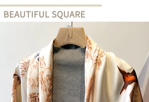 Detail of a large cream silk scarf with brown forest and animal totem prints on a hanger