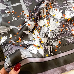 Close-up of elegant floral and bridge pattern on premium satin silk scarf fabric