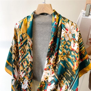 Detailed view of 110cm floral silk scarf with magnolia prints and geometric lines