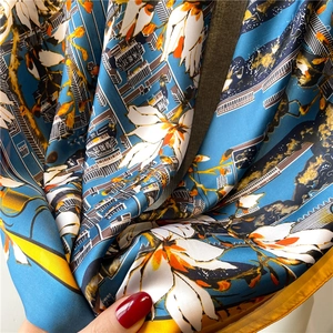 Detailed texture of silk scarf featuring Chinese palace prints and magnolia flowers