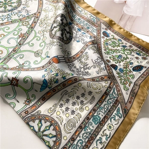 Close-up of vintage celestial sun and star patterns on silk satin square scarf
