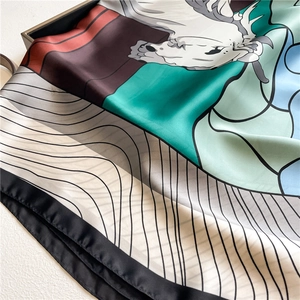 Detailed view of luxury silk scarf showing artistic horse print and fine rolled edges