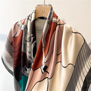 Detailed close-up of large art print satin scarf with abstract pattern in neutral tones