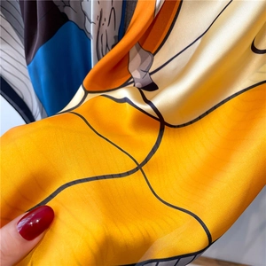 Detail of vibrant pop art pattern on 110cm satin scarf with yellow and blue hues