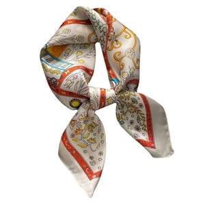 Elegant geometric floral silk scarf with orange borders in a stylish knotted display
