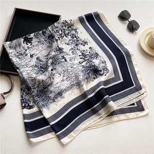Classic 110cm blue floral satin square scarf shown with luxury lifestyle accessories