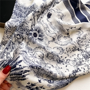 Elegant Toile de Jouy silk scarf in ivory and navy blue with detailed sun and bird patterns