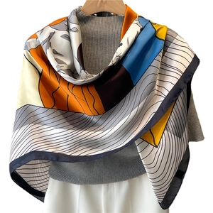 Elegant large 110cm satin silk scarf with colorful geometric prints on a hanger