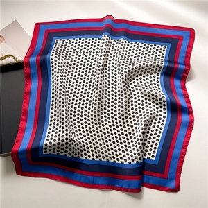 Close-up of polka dot silk scarf with red and blue borders and elegant drape