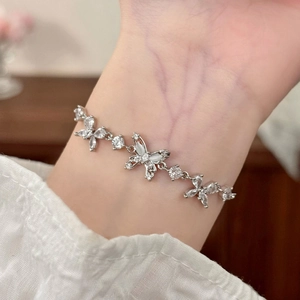 Elegant adjustable silver butterfly bracelet with cubic zirconia on model's wrist