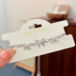 Macro detail of silver-tone butterfly bracelet with cubic zirconia and adjustable slide clasp