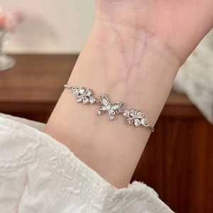 Elegant silver butterfly bracelet with cat-eye stones and adjustable pull chain for women