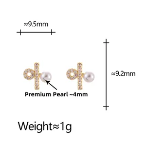 Detail showing dimensions of minimalist gold pearl stud earrings with zircon cross design