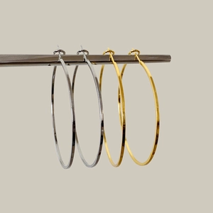 Minimalist large geometric hoop earrings in polished gold and silver metal finishes