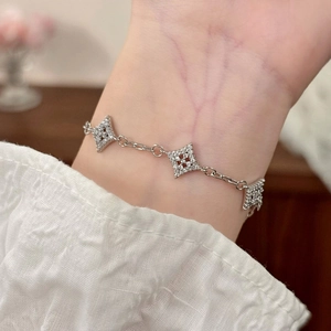 Macro detail of silver star bracelet with micro-pave zircons on a model's wrist