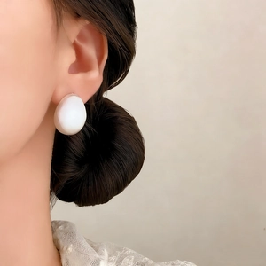 Minimalist oval brushed stud earrings shown on model for elegant daily jewelry style