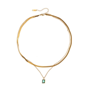 Double-layered gold necklace with flat snake chain and green emerald pendant