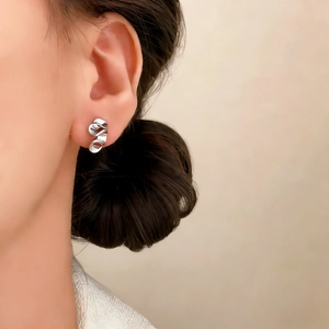 Elegant silver wavy ribbon stud earrings for women in a minimalist polished metal design
