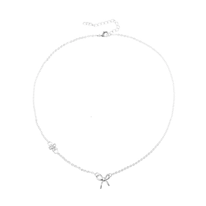 Minimalist silver bow pendant necklace with adjustable chain on white background