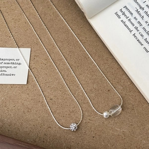 Detail of silver snake chain with micro-pave zircon sphere pendant and beaded design