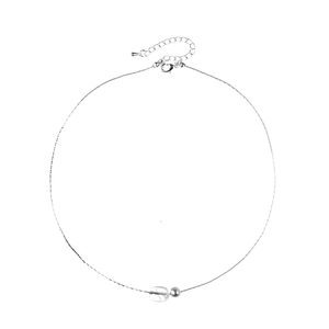 Detail of silver necklace featuring a clear bean pendant, metal bead, and lobster clasp