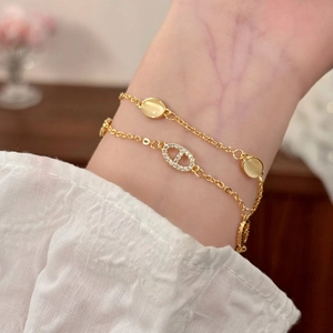 Bracciale dorato a doppio strato con pietra occhio di gatto e dettaglio con strass