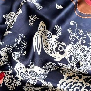 Lustrous blue satin scarf featuring elegant white rabbit and floral patterns
