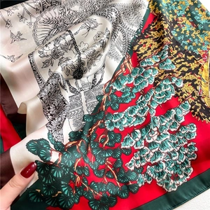 Detail of premium silk scarf featuring classical oriental pine and bird digital print