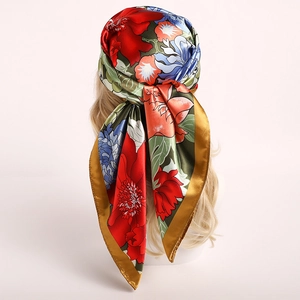 Elegant 90cm floral silk scarf with vibrant flower patterns and gold trim on a mannequin