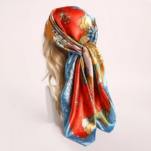 Close-up of elegant floral satin scarf tied as a headband on a blonde mannequin