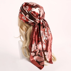 Detail of floral satin scarf styled as headscarf with vintage floral pattern