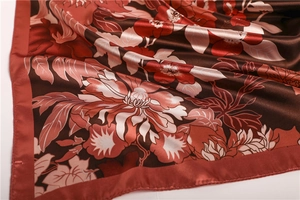 Detailed close-up of premium satin silk floral scarf with elegant blooming peony pattern