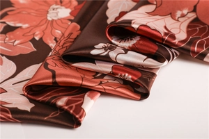 Detailed view of satin floral scarf showing smooth texture and elegant flower pattern