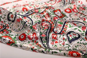 Macro shot of paisley and floral silk scarf fabric showing smooth texture and drape