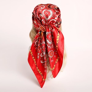 Elegant red paisley satin scarf worn as a stylish headwrap with floral vine patterns