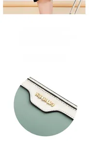 Macro shot of cream and green PU leather shell bag showing gold brand hardware details