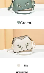 Detailed embroidery craft on green and cream shell-shaped crossbody handbags