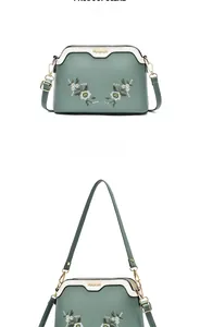 Detail of Morandi green shell bag with white flower embroidery and golden metal logo