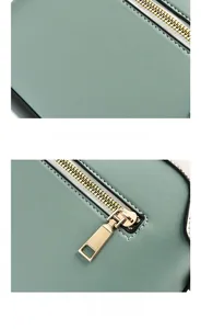 Detail of Morandi green leather bag showing textured fabric and light gold metal zipper