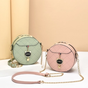 Chic quilted round crossbody bags with cat charms in mint green and dusty rose